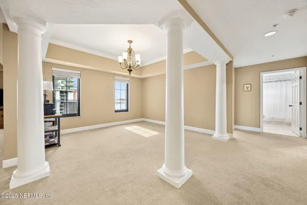 a view of a livingroom with a furniture chandelier and a fireplace