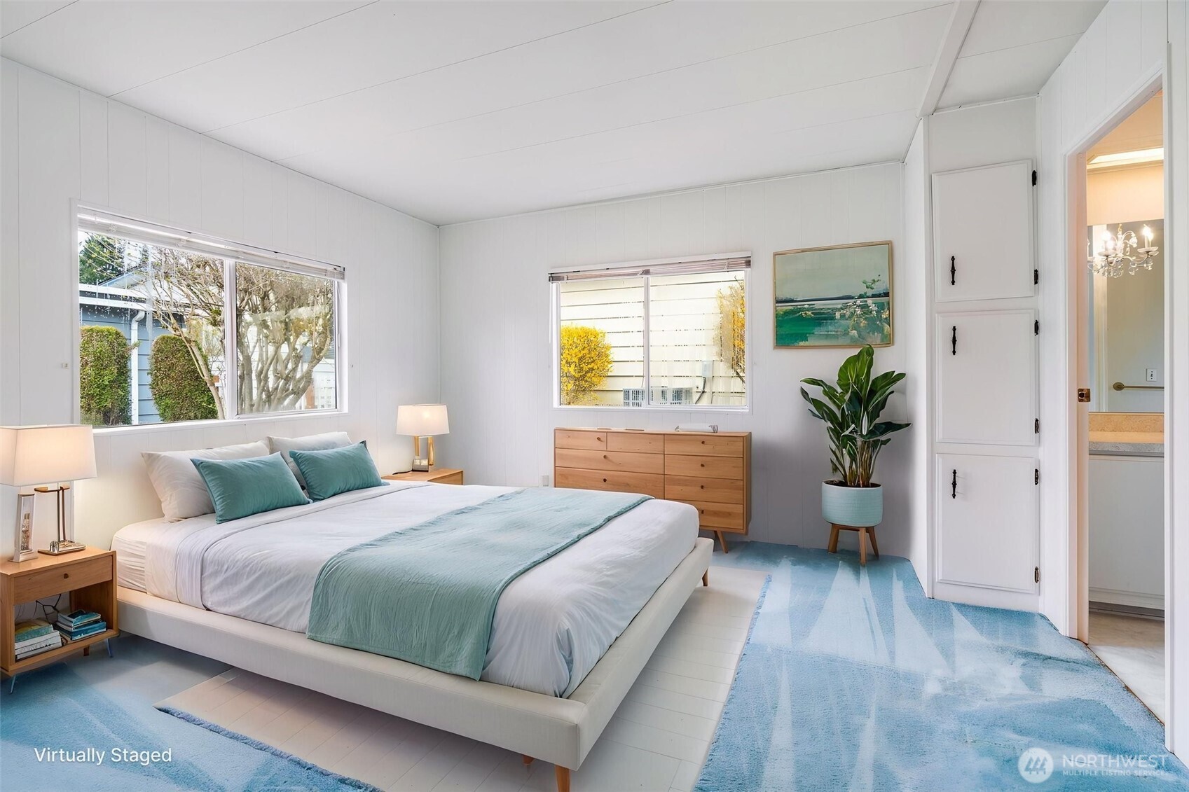 201 Union Avenue Southeast, Unit 111 Renton, WA 98059 - Photo 15 of 40 a bedroom with a large bed potted plant and windows