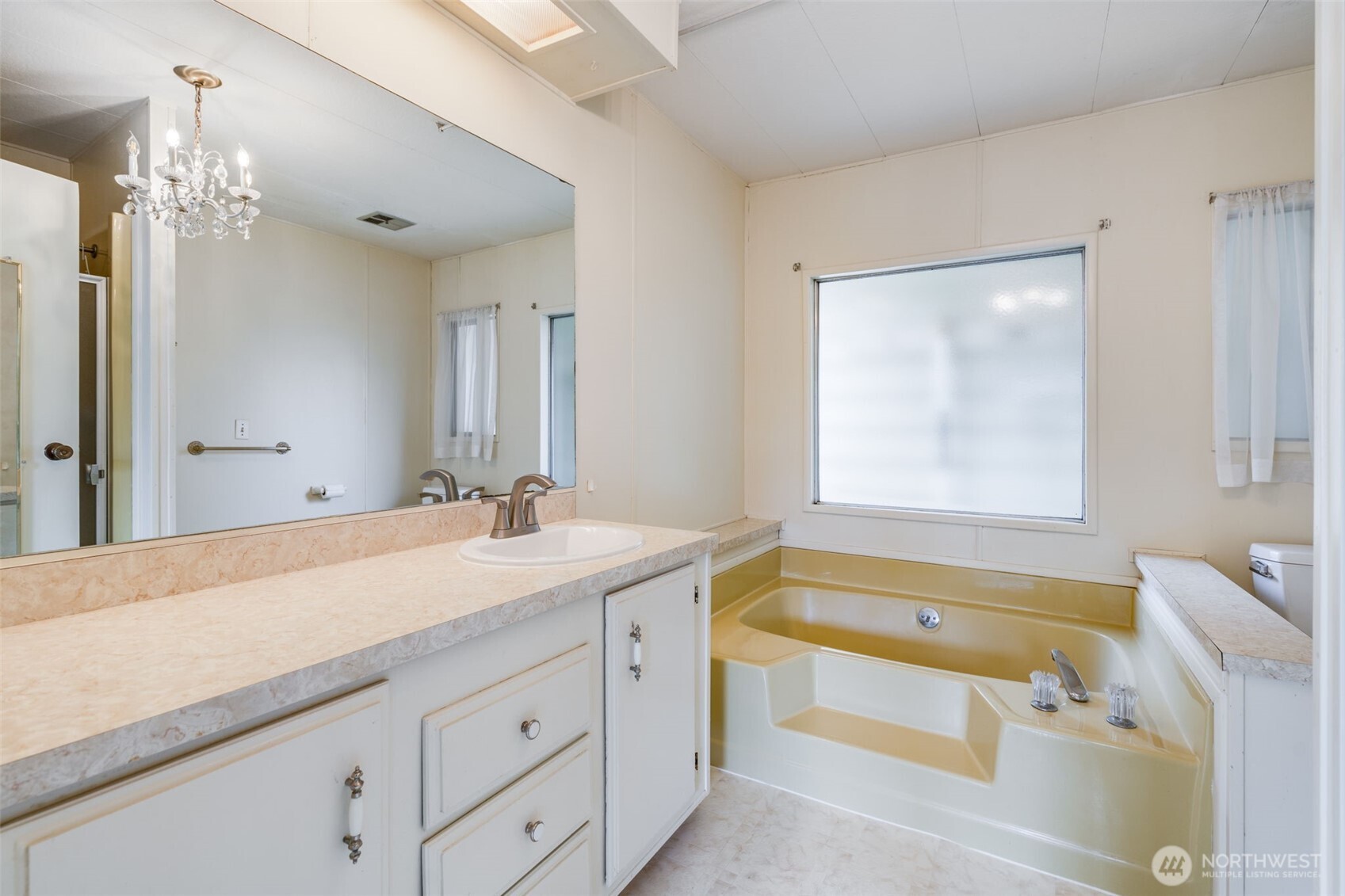 201 Union Avenue Southeast, Unit 111 Renton, WA 98059 - Photo 18 of 40 a bathroom with a tub sink and mirror