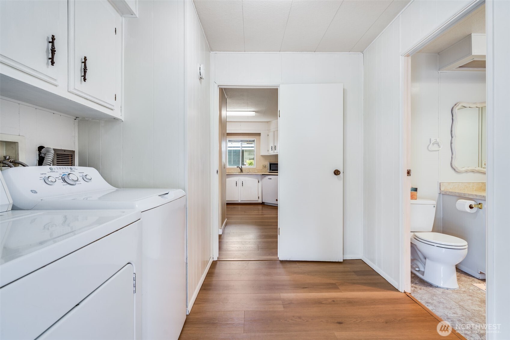 201 Union Avenue Southeast, Unit 111 Renton, WA 98059 - Photo 24 of 40 a view of a hallway with wooden floor and a bathroom