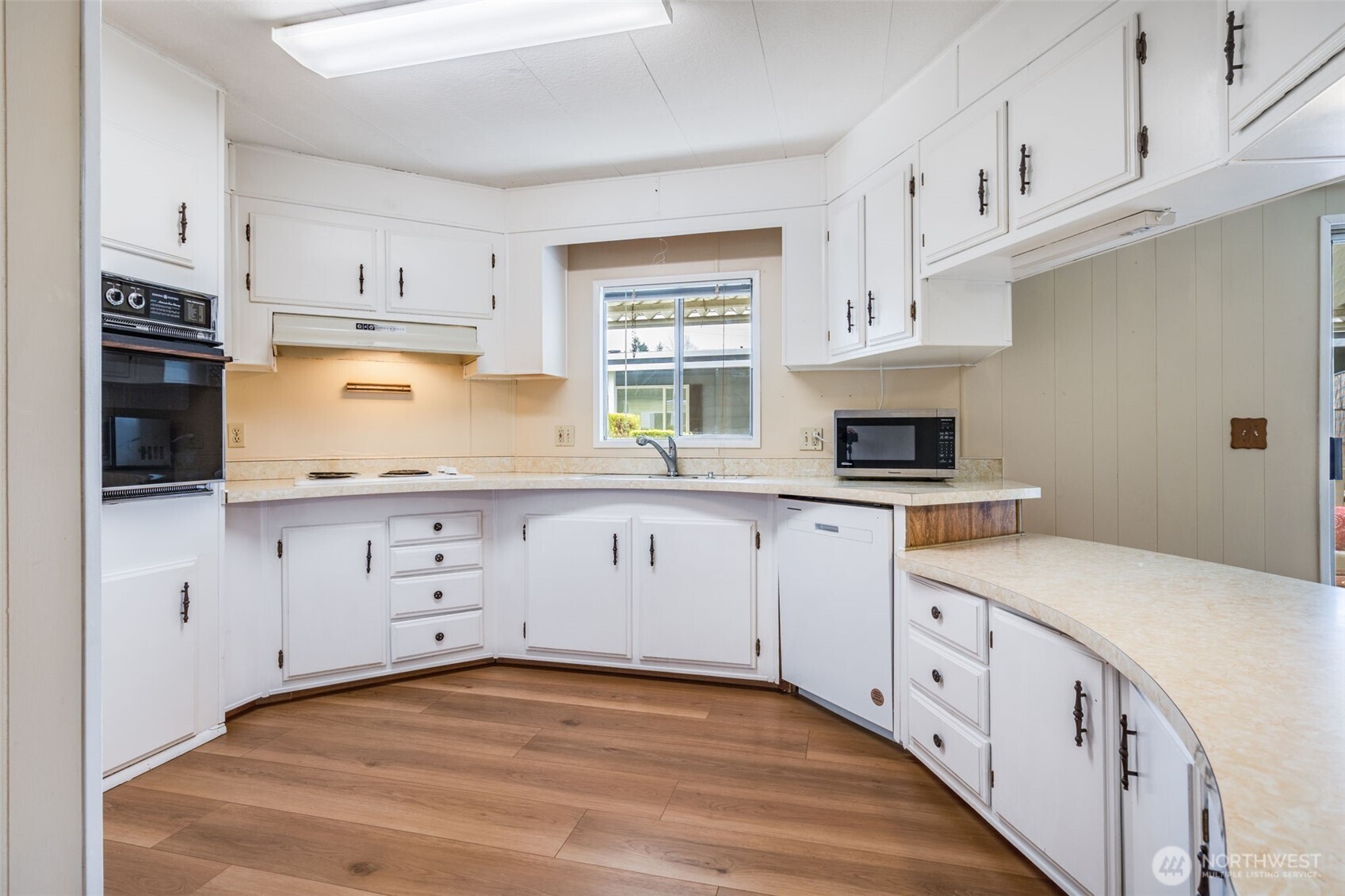 201 Union Avenue Southeast, Unit 111 Renton, WA 98059 - Photo 10 of 40 a kitchen with granite countertop white cabinets white stainless steel appliances and sink