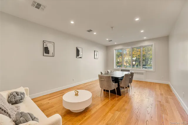 a view of a dining room with a table and chairs