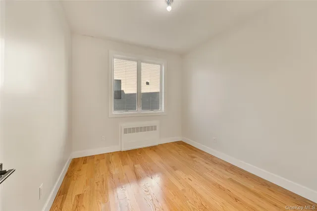 a view of a room with wooden floor and cabinet