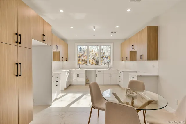 a kitchen with stainless steel appliances granite countertop a refrigerator and a stove top oven