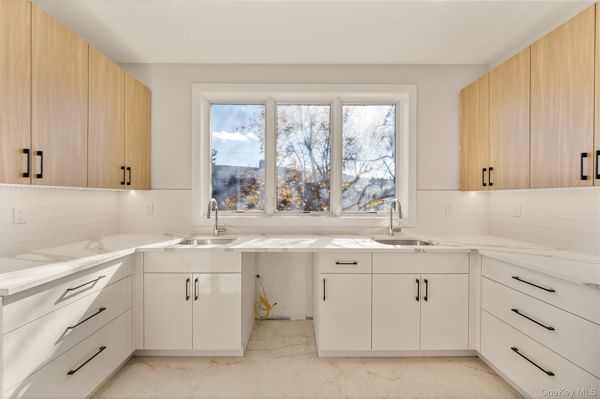 17 Lazer Court, Unit 202 Spring Valley, NY 10977 - Photo 19 of 40 a kitchen with white cabinets window and sink
