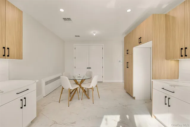 a view of kitchen with refrigerator and window