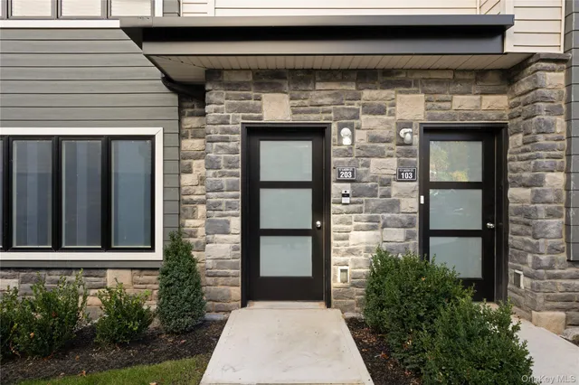 a front view of a house with large windows