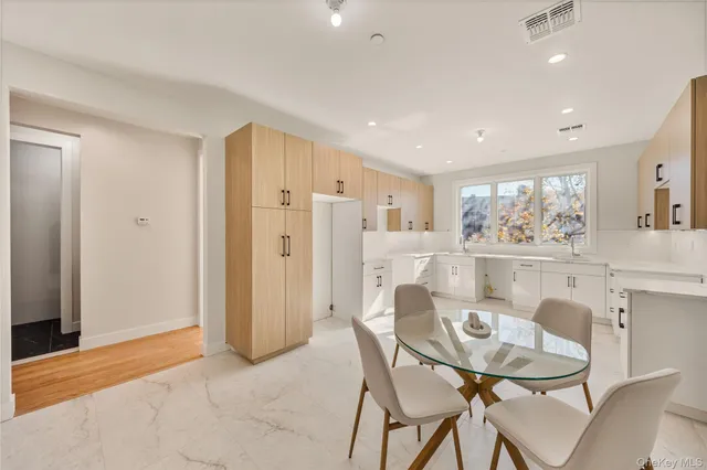 a view of a dining room with furniture and a potted plant