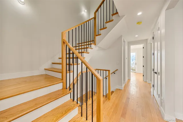a view of staircase with wooden floor and a rug