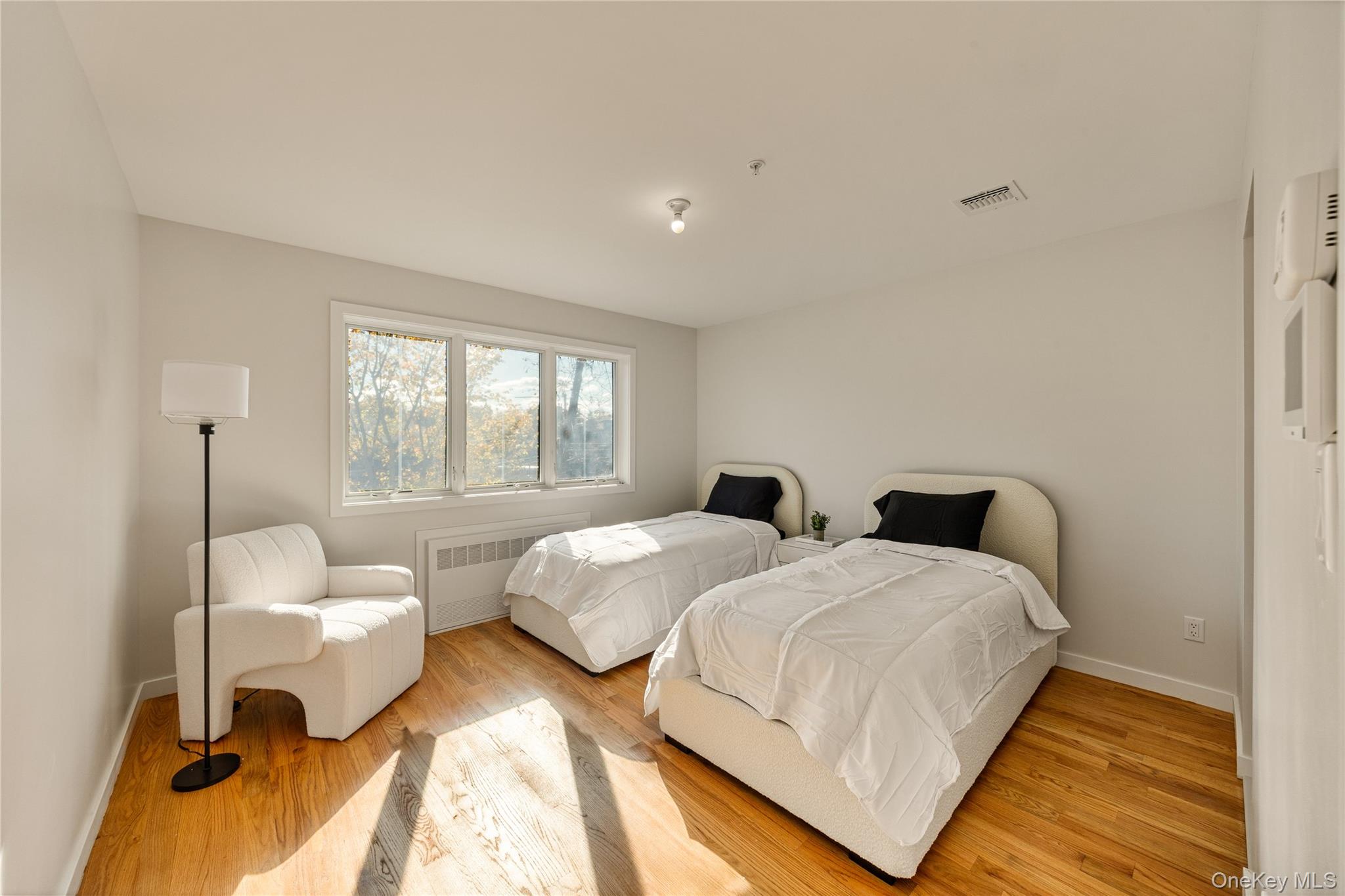 17 Lazer Court, Unit 202 Spring Valley, NY 10977 - Photo 26 of 40 a bedroom with two beds and a large window
