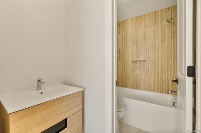 a bathroom with a bathtub and shower