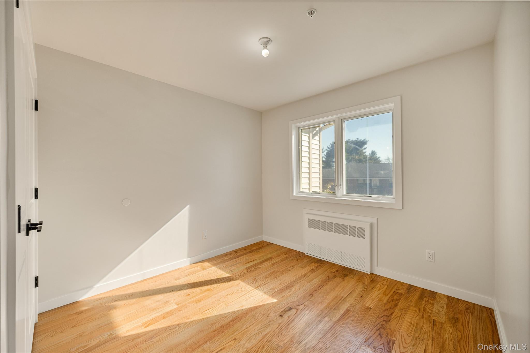17 Lazer Court, Unit 202 Spring Valley, NY 10977 - Photo 33 of 40 a view of empty room with wooden floor and fan