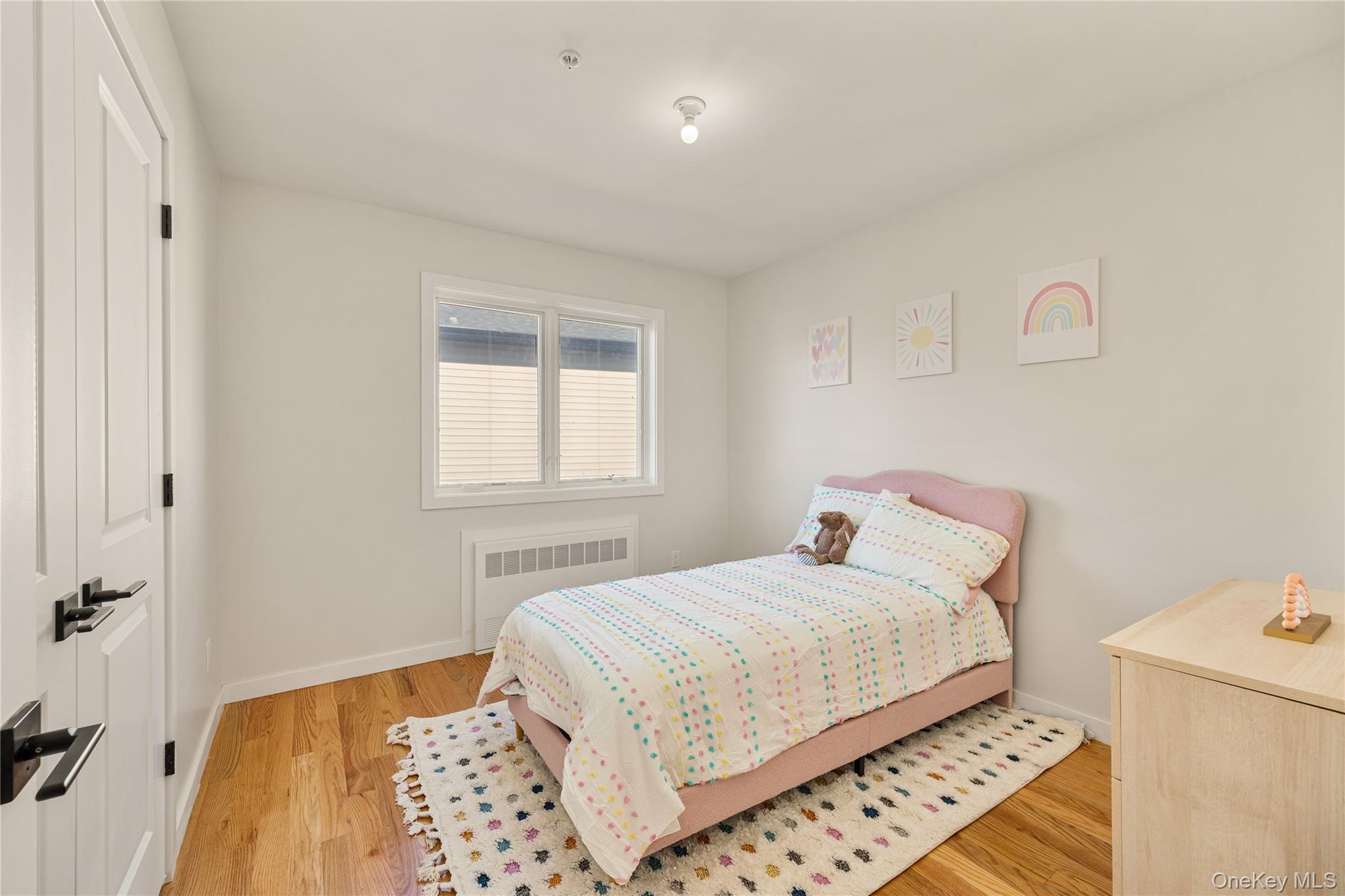 17 Lazer Court, Unit 202 Spring Valley, NY 10977 - Photo 35 of 40 a bedroom with a bed and wooden floor
