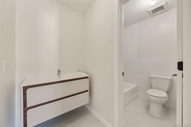 a bathroom with a toilet sink and shower