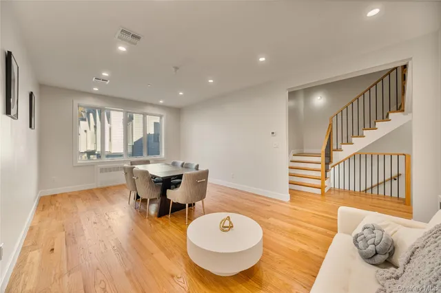 a living room with dining room and wooden floor