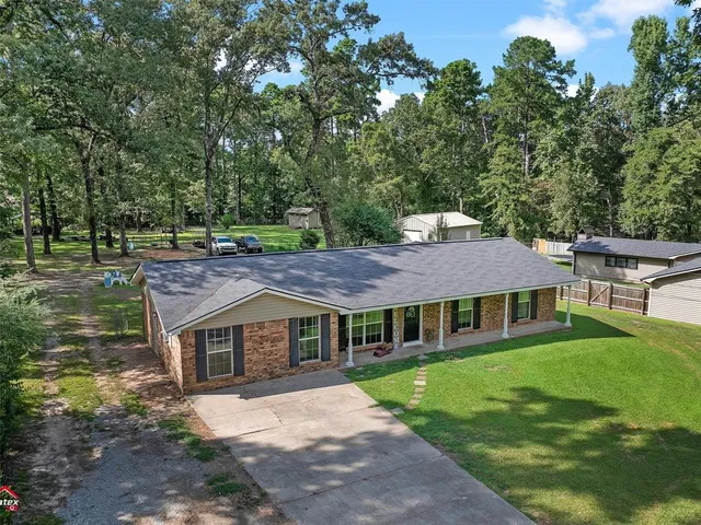 a aerial view of a house with a yard