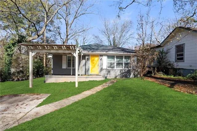 a view of a house with a yard porch and sitting area
