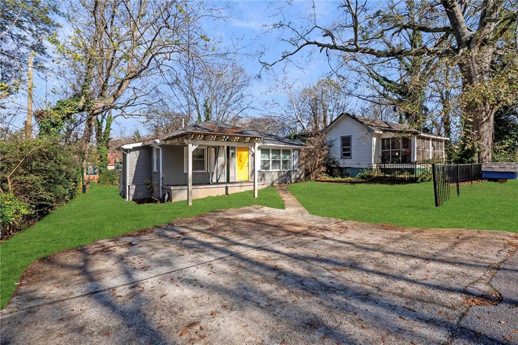 200 Meador Way Southeast Atlanta, GA 30315 - Photo 2 of 6 a front view of a house with a yard and garage