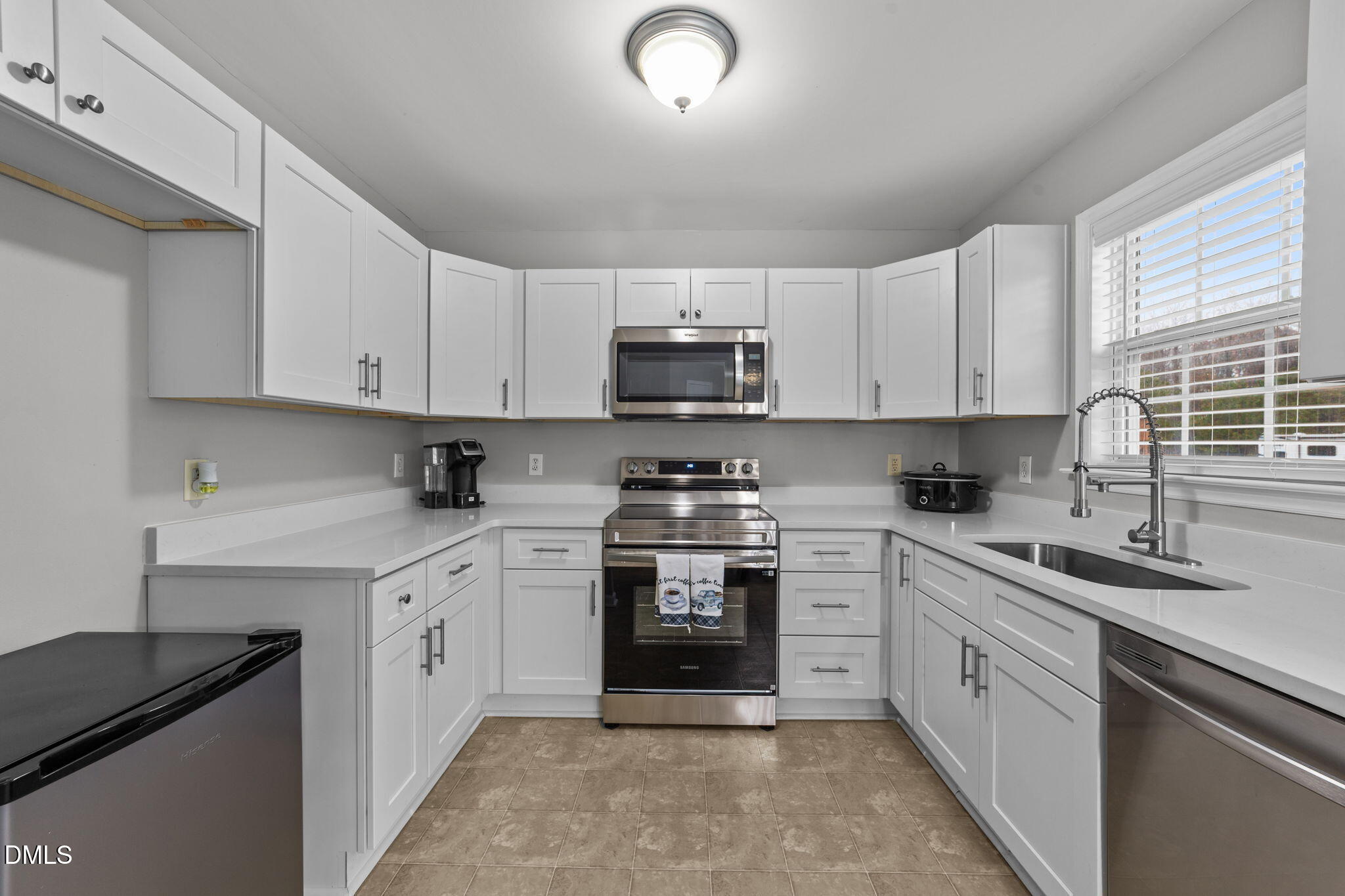 1275 Smith Road Smithfield, NC 27577 - Photo 10 of 41 a kitchen with cabinets appliances a sink and a window