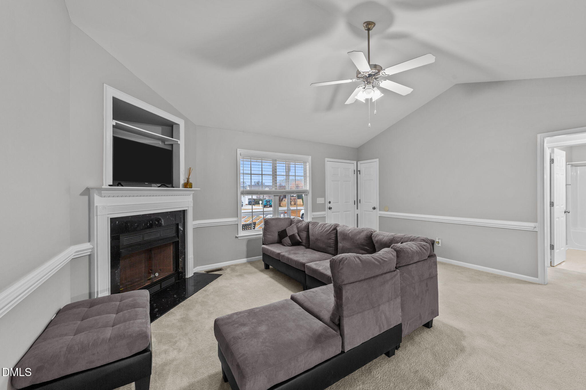 1275 Smith Road Smithfield, NC 27577 - Photo 4 of 41 a living room with furniture a fireplace and a flat screen tv