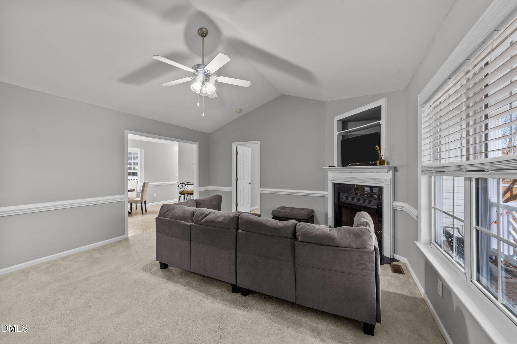 1275 Smith Road Smithfield, NC 27577 - Photo 6 of 41 a living room with furniture a fireplace and a flat screen tv