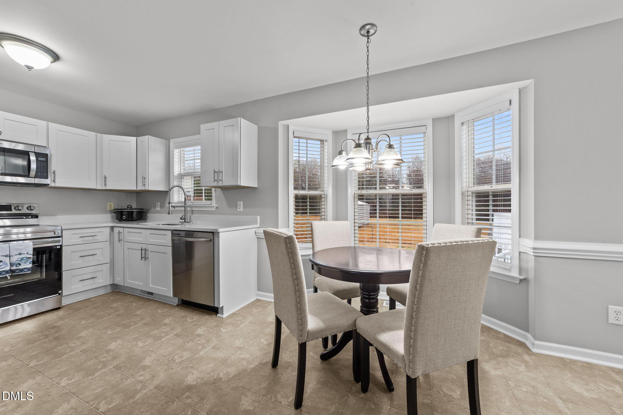 1275 Smith Road Smithfield, NC 27577 - Photo 7 of 41 a kitchen with stove a sink and chairs