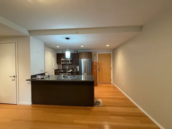 a view of kitchen and kitchen with stainless steel appliances