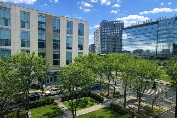 a view of building with garden space and street view