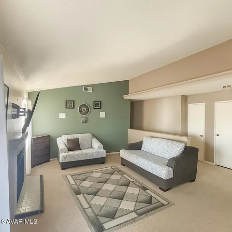 a living room with furniture and a lamp