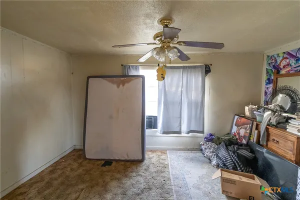 a living room with furniture gym equipment and a window