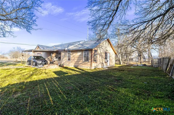a view of an house with backyard space and garden