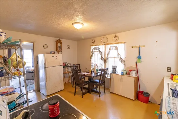 a living room with furniture a dining table and a large window