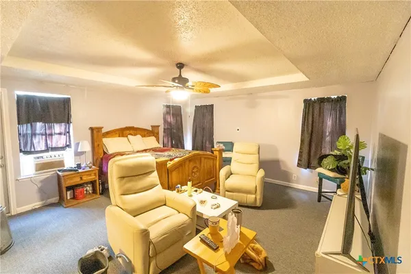 a bedroom with furniture and a flat screen tv