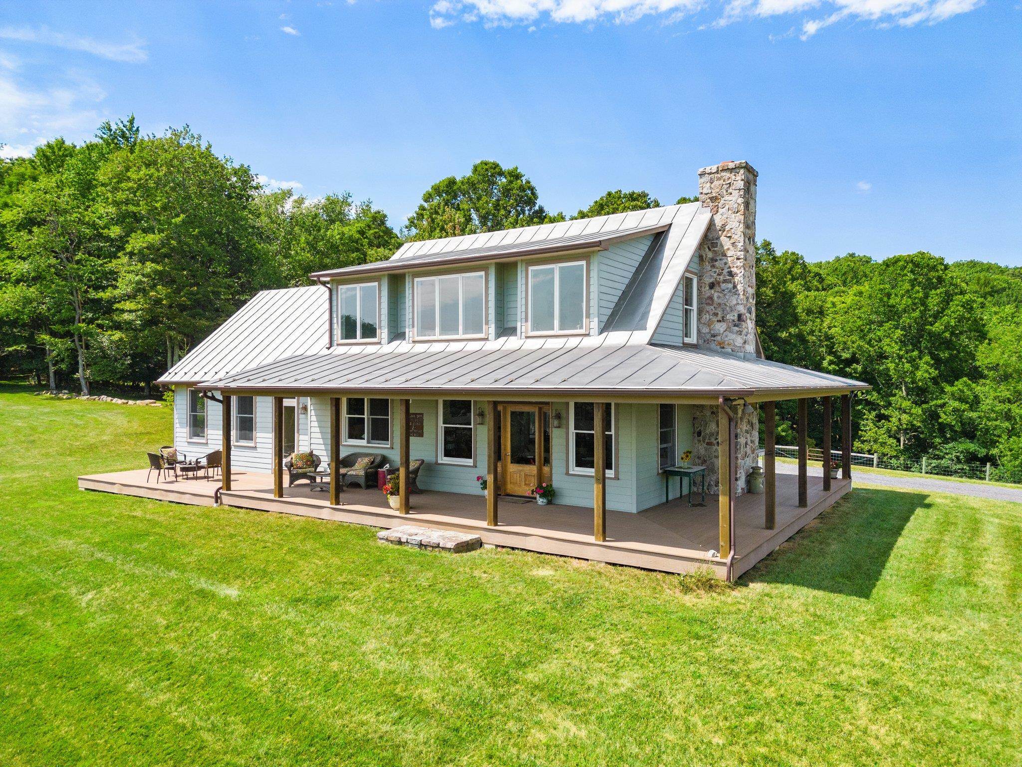 a view of a house with a yard porch and sitting area