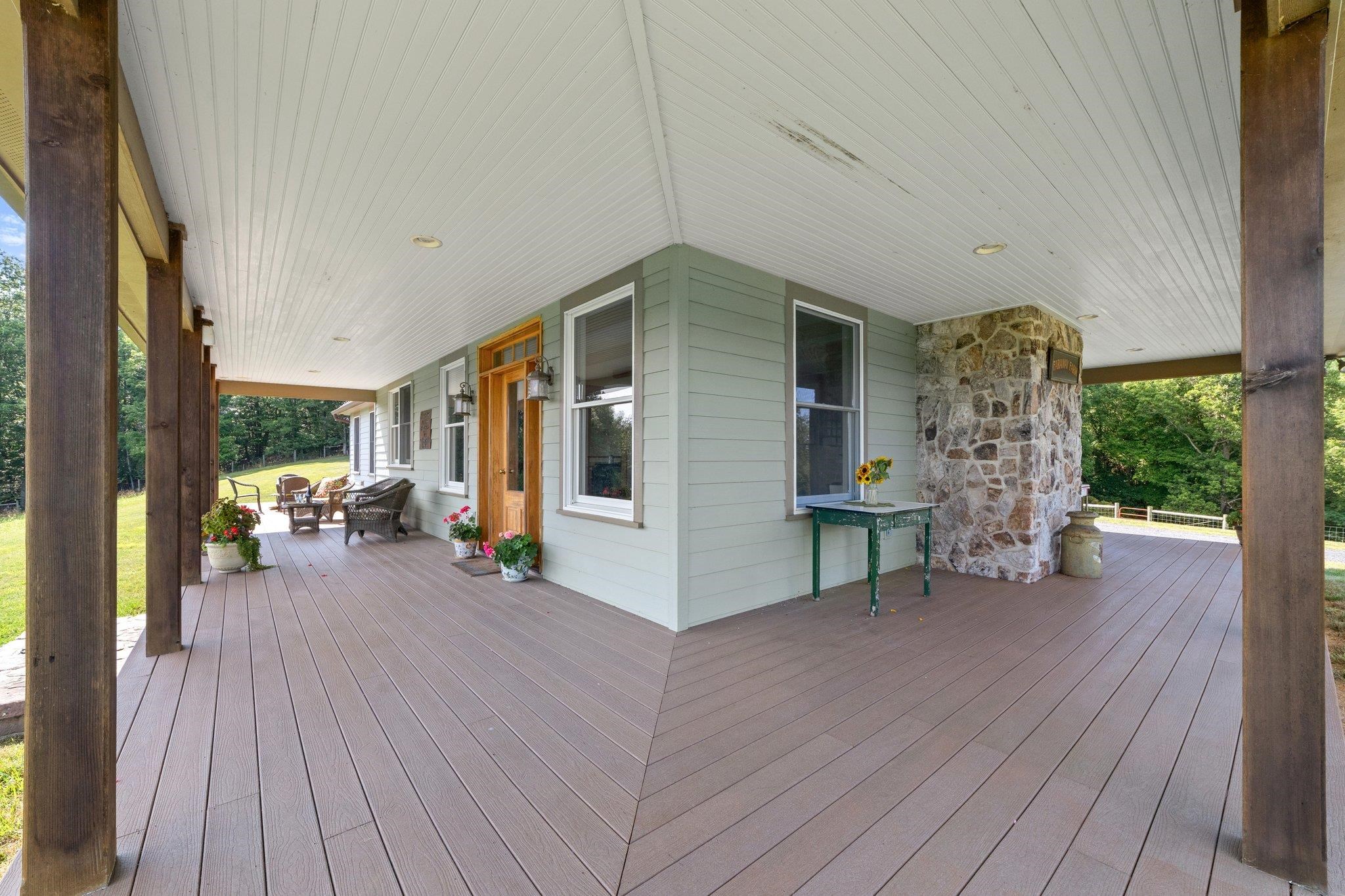 5237 Doe Hill Road McDowell, VA 24458 - Photo 19 of 75 a view of a patio with table and chairs with wooden floor and fence