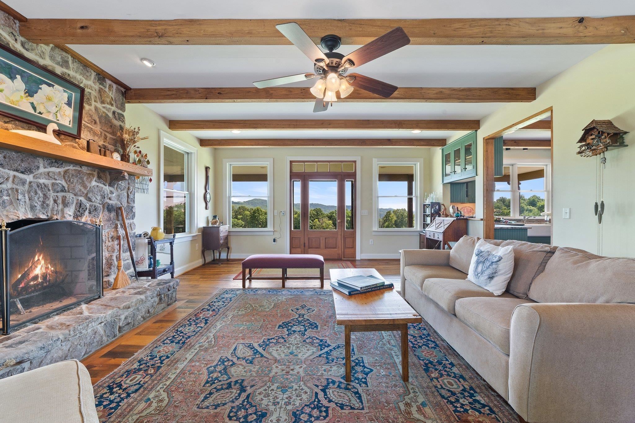 5237 Doe Hill Road McDowell, VA 24458 - Photo 32 of 75 a living room with furniture a chandelier and a fireplace