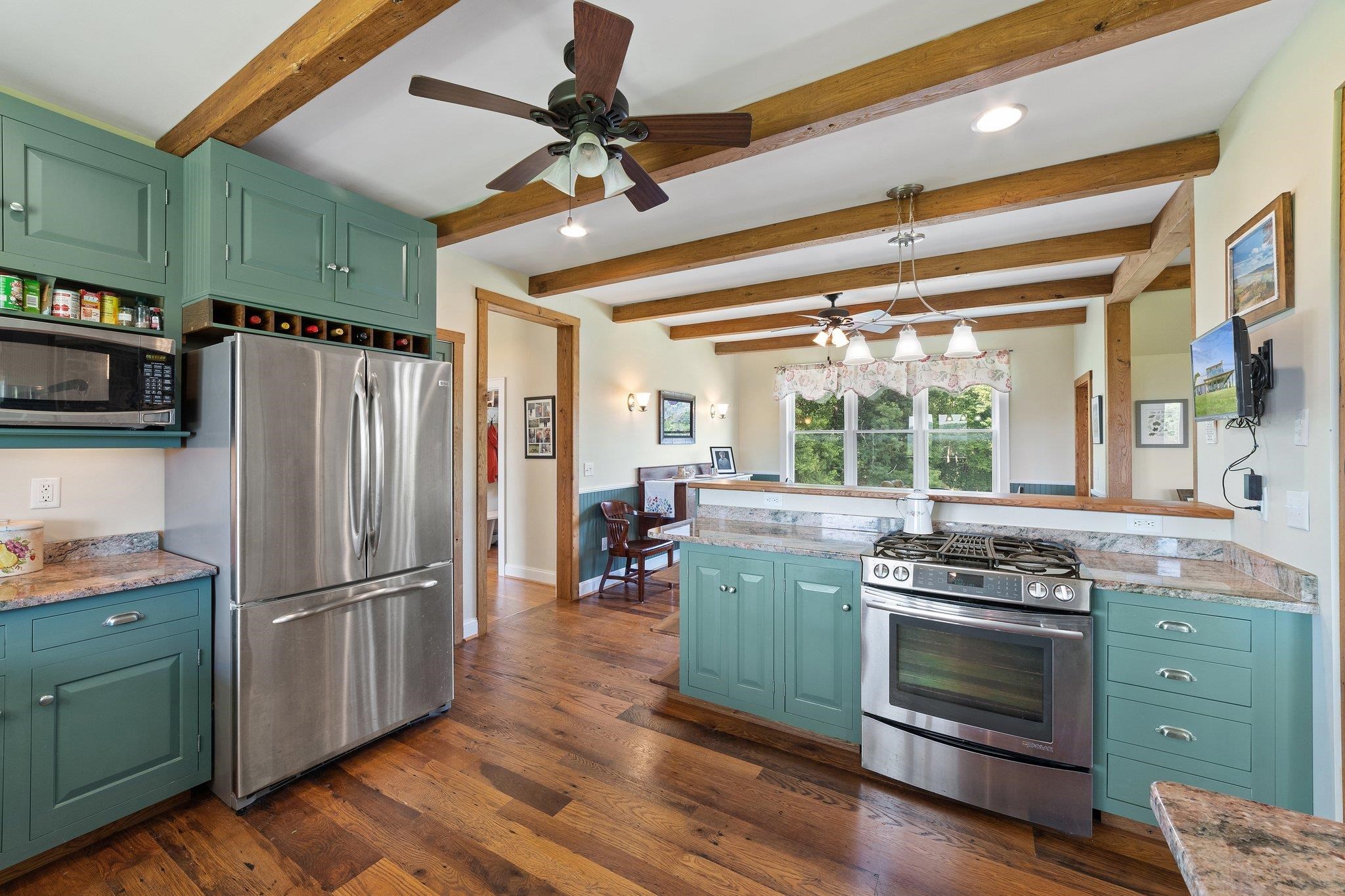 5237 Doe Hill Road McDowell, VA 24458 - Photo 38 of 75 a kitchen with granite countertop stainless steel appliances and wooden floor