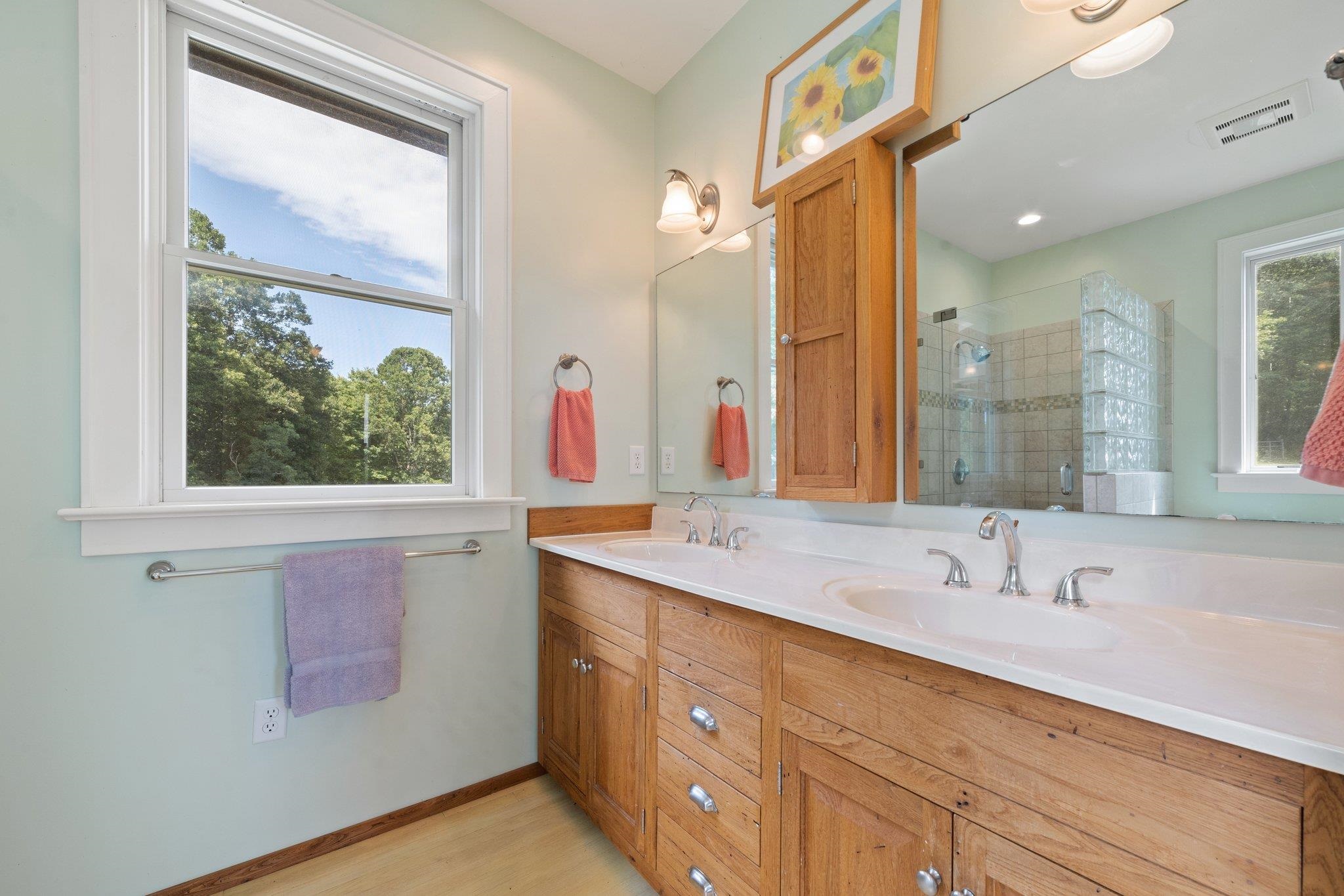 5237 Doe Hill Road McDowell, VA 24458 - Photo 45 of 75 a bathroom with a sink and a large mirror next to a window
