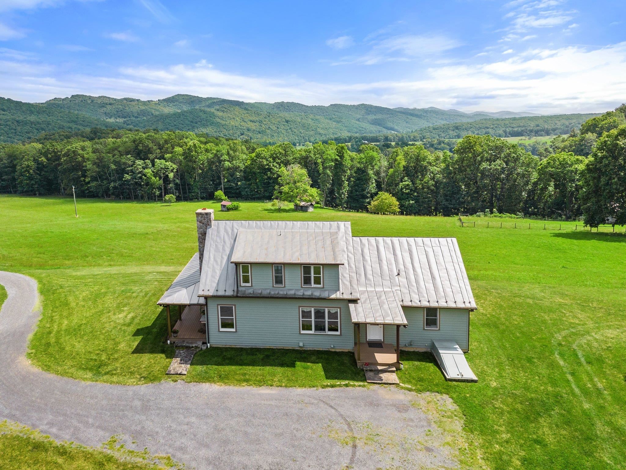 5237 Doe Hill Road McDowell, VA 24458 - Photo 7 of 75 a view of a big house with a big yard potted plants and large tree