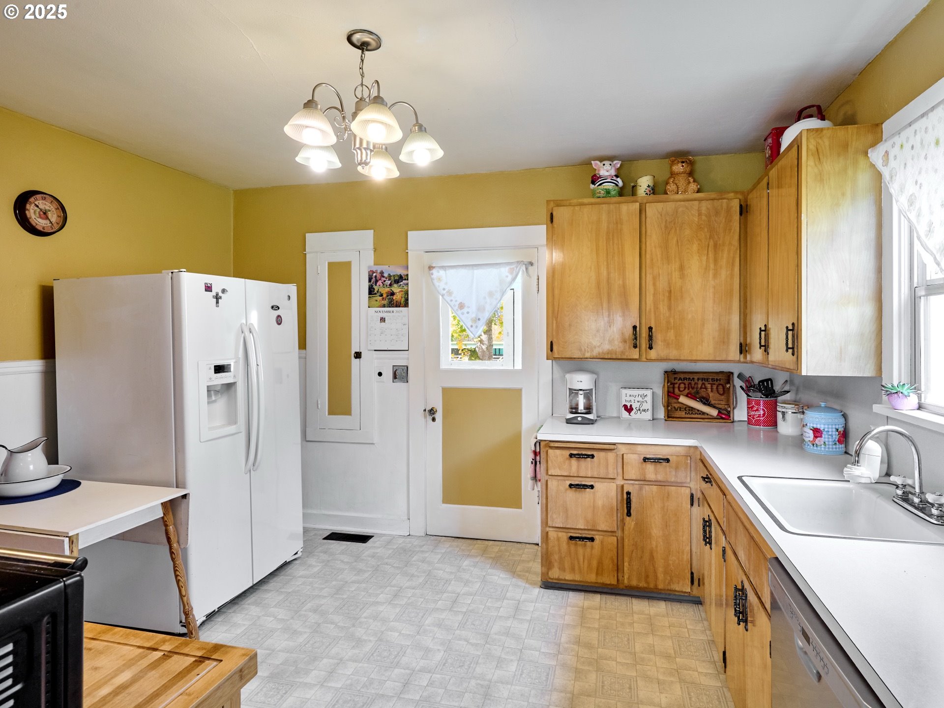 13595 South Warrick Road Molalla, OR 97038 - Photo 12 of 48 a kitchen that has a lot of cabinets stainless steel appliances and a chandelier