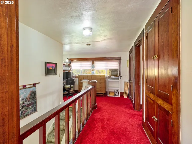 a bedroom with a bed and a dresser next to a window