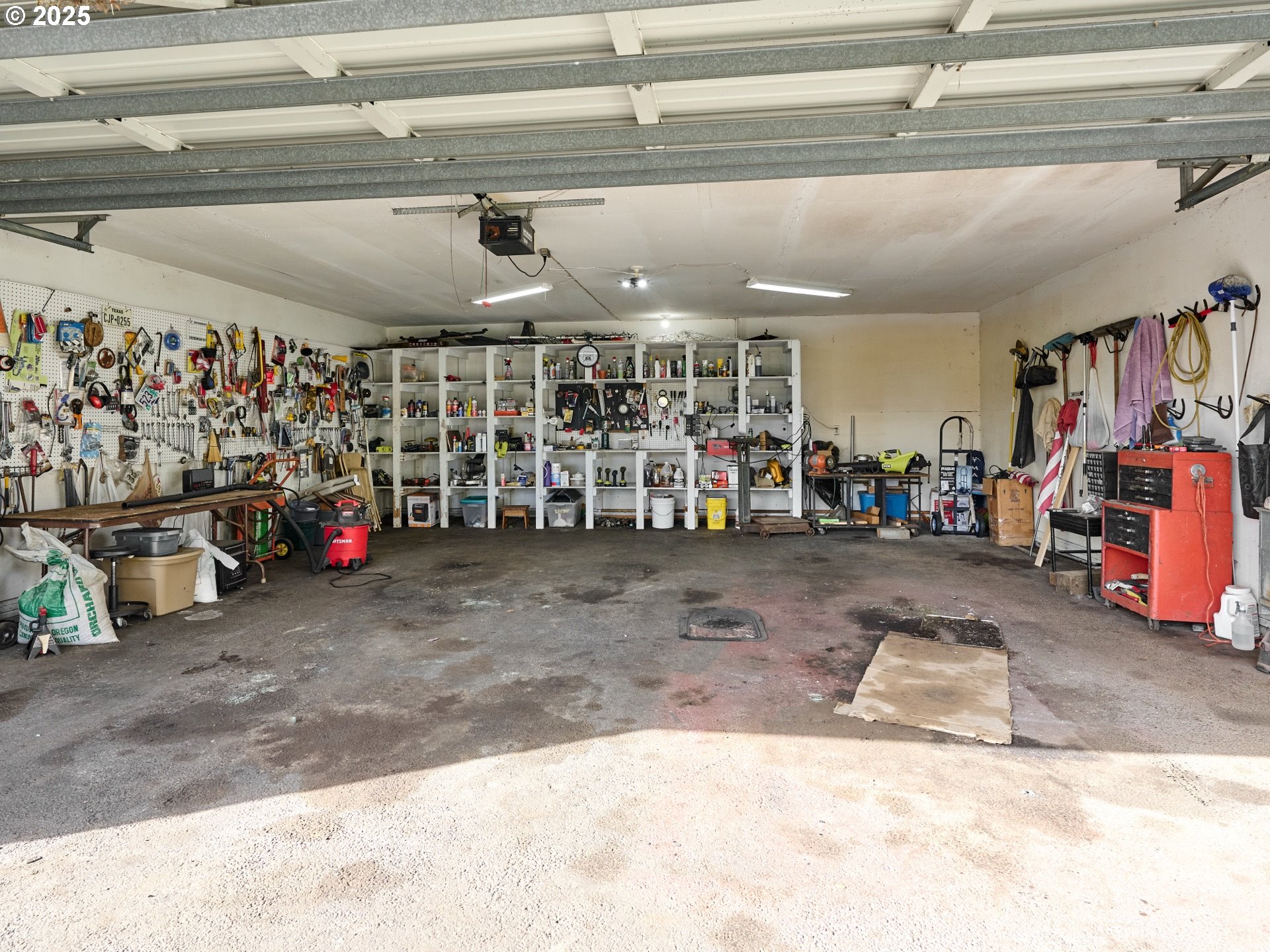 13595 South Warrick Road Molalla, OR 97038 - Photo 27 of 48 a view of a garage with a bike and car