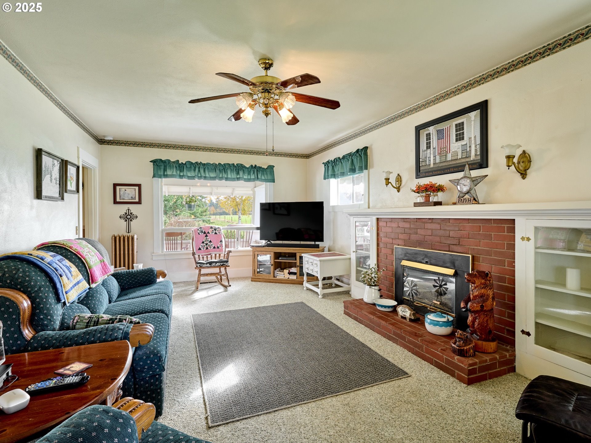 13595 South Warrick Road Molalla, OR 97038 - Photo 3 of 48 a living room with furniture a flat screen tv and a fireplace