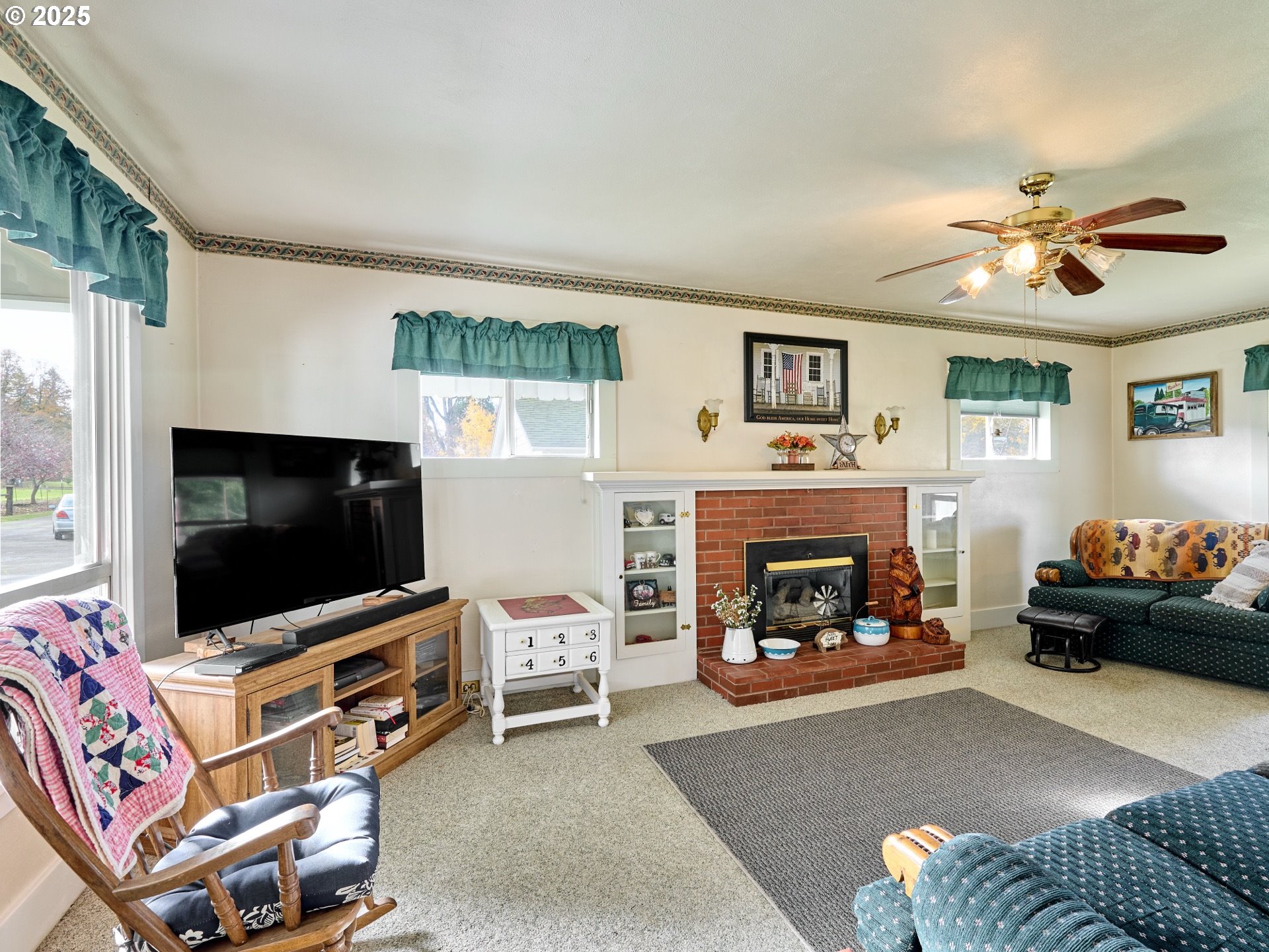 13595 South Warrick Road Molalla, OR 97038 - Photo 4 of 48 a living room with furniture a flat screen tv and a fireplace