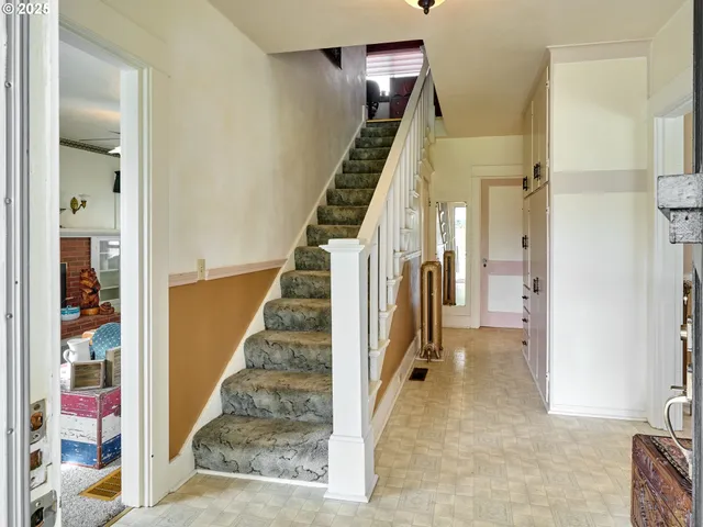 a view of a hallway with paintings on the wall