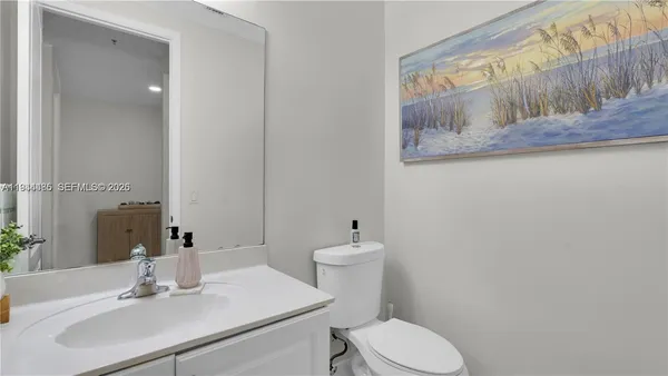 a bathroom with a sink a toilet and mirror