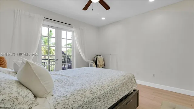 a large bed sitting in a bedroom next to a window
