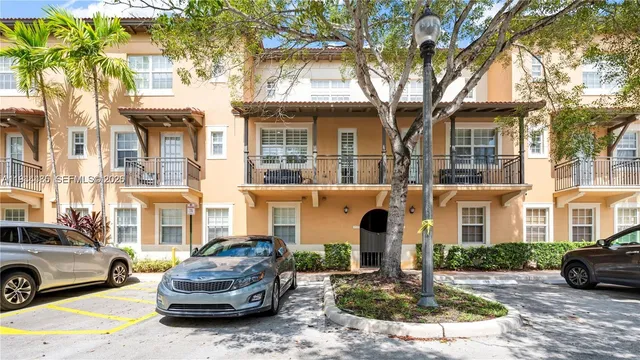 a car parked in front of a brick house