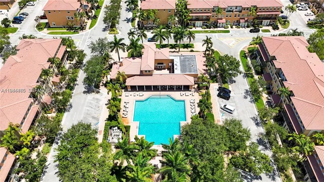 an aerial view of multiple houses with yard