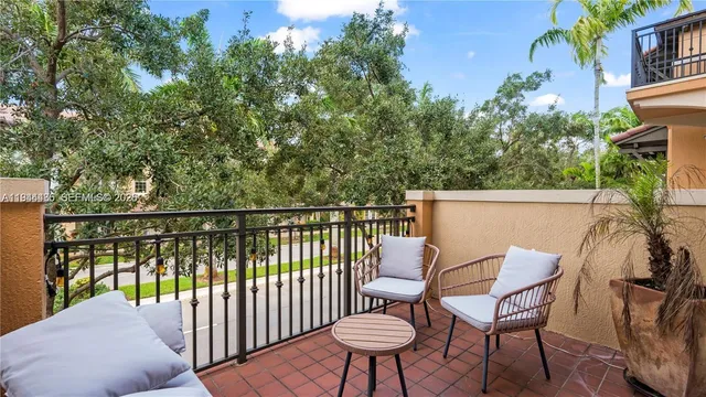 a view of a chairs and table in the balcony